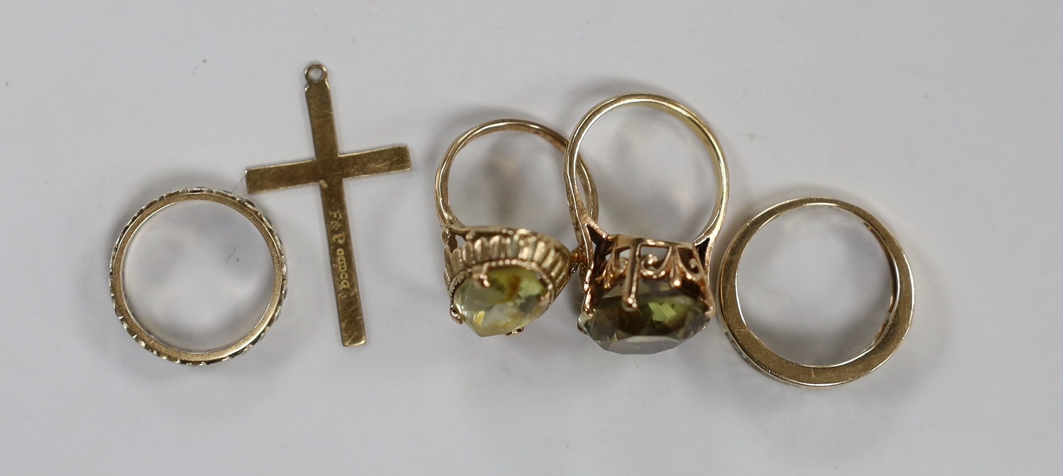 Three 9ct gold and gem set rings, gross 13.4 grams, a 9ct gold cross and one other yellow metal ring.